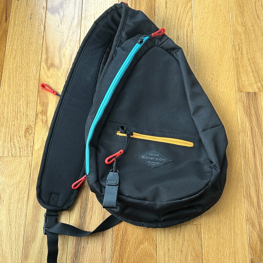 Sherpani Black Crossbody Bag with Teal and Orange Accents